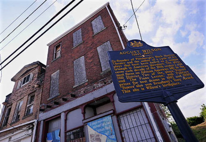 Playwright August Wilson in the Hill District on Bedford Avenue in the rear of his mother Daisy's home. Wilson grew up at another house on Bedford Avenue. 
