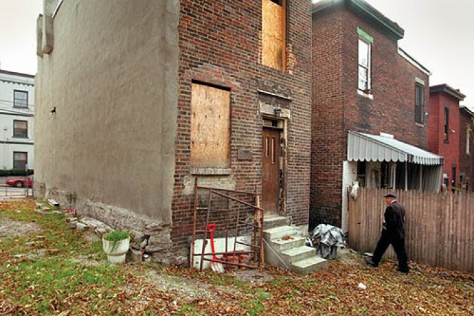 Playwright August Wilson in the Hill District on Bedford Avenue in the rear of his mother Daisy's home. Wilson grew up at another house on Bedford Avenue.
